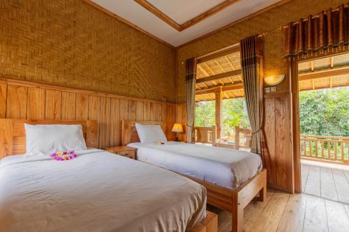 Ένα ή περισσότερα κρεβάτια σε δωμάτιο στο Mulia Garden Bungalows - Monthly Rate Available