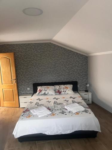 a bedroom with a bed and a wall with at Apartman Bojanić in Trebinje