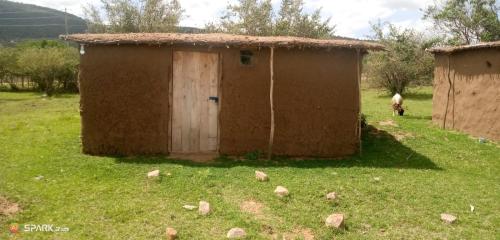 a small shack in the middle of a field at Nadupa homestay Maasai Mara in Sekenani