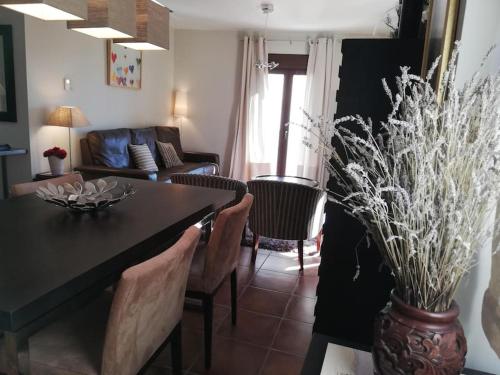 a living room with a table and chairs and a couch at Céntrico dúplex con vistas, en Morella in Morella