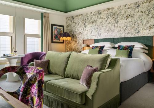 a hotel room with a bed and a couch at Dylan in Dublin