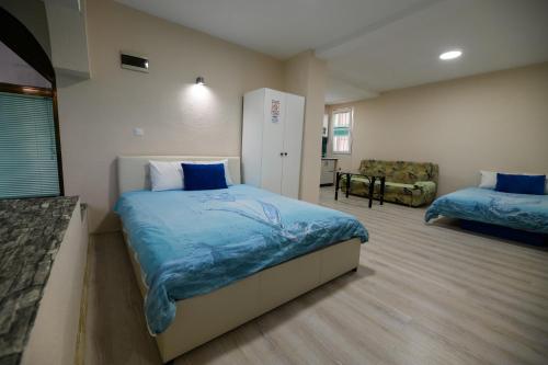 a bedroom with a bed and a chair in it at Rose's Apartment in Prilep