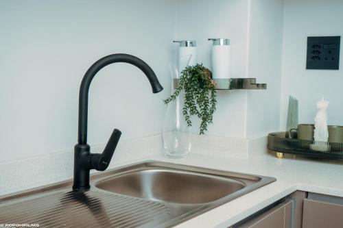 a kitchen sink with a faucet in a kitchen at Green with Envy-Luxury Apartment- No Loadshedding in Johannesburg
