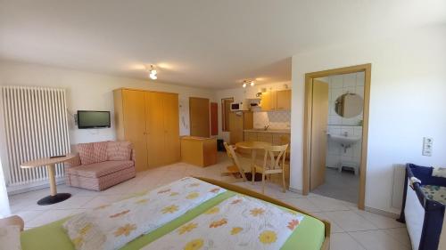 1 dormitorio con 1 cama y sala de estar en Ferienhof Metzler, en Bodnegg