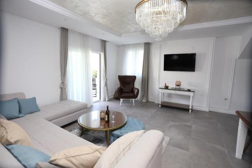 a living room with a couch and a table at Apartments Cukovic in Herceg-Novi