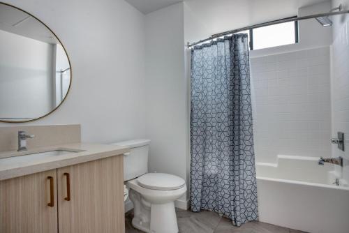 a bathroom with a toilet and a sink and a mirror at Culver City 1br w rooftop lounge access to 405 LAX-1124 in Los Angeles
