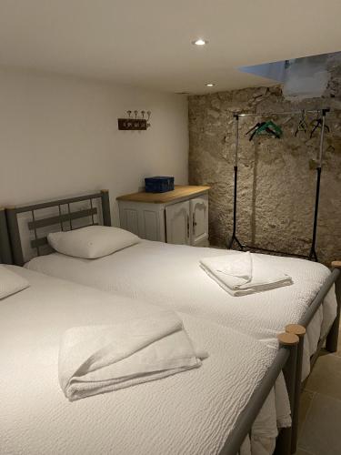 a bedroom with two beds with towels on them at Gite des vieilles pierres in Seigy