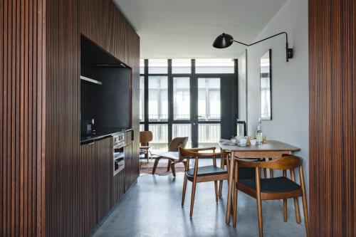 a kitchen and dining room with a table and chairs at Lisbon Five Stars Alcântara Lofts in Lisbon
