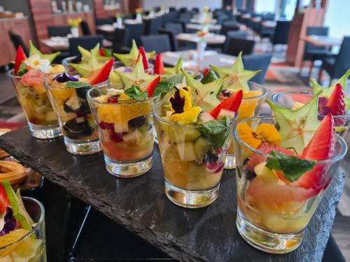 a group of glasses filled with different types of fruit at Warsaw Plaza Hotel in Warsaw
