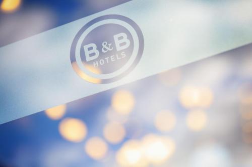 a logo for b b hotels on a wall at B&B HOTEL Besançon Valentin in Besançon