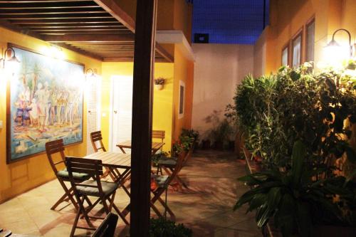 a patio with a table and chairs and plants at Kira's Boutique Hotel in Mindelo