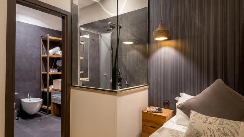 a bathroom with a shower and a sink and a toilet at QT Suites Roma in Rome
