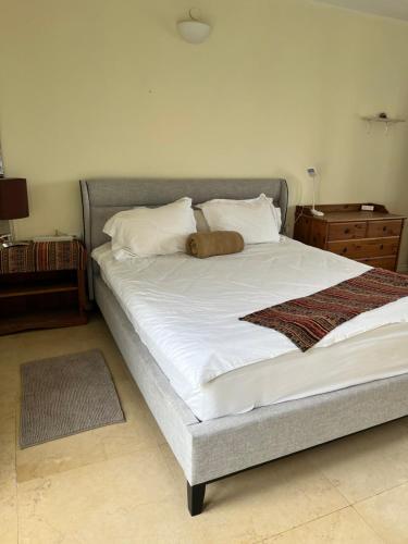 a bedroom with a large bed with white sheets and pillows at Artists Colony Inn Zefat in Safed