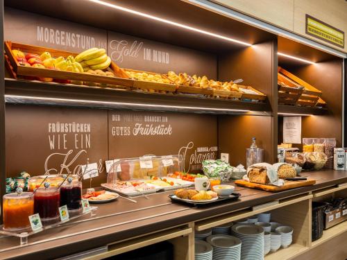 a bakery with a buffet of food on display at B&B Hotel Essen in Essen