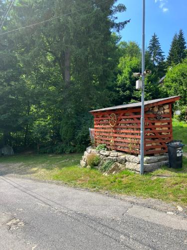 a log cabin on the side of a road at Penzion Tereza in Janov nad Nisou