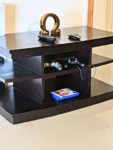 a black table with a mirror on top of it at Sweet Holiday Haven in Ocho Rios