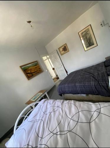 a bedroom with a bed and a table in it at The Old School House in Céaucé