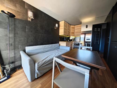 a living room with a couch and a table at Hostdomus - Oak Luxury Suite in Sestriere