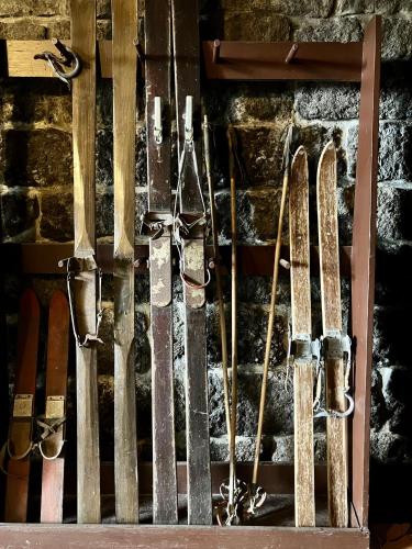 a bunch of skis and snowboards hanging on a wall at Penzion Tereza in Janov nad Nisou