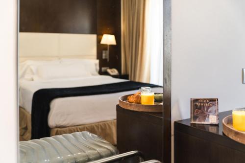 a hotel room with a bed and a table with orange juice at Hotel Taburiente S.C.Tenerife in Santa Cruz de Tenerife