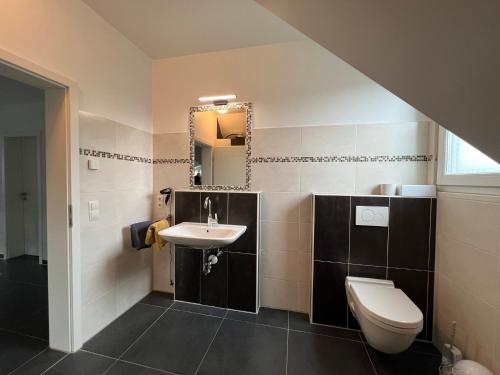 a bathroom with a sink and a toilet at Ferienwohnung Wicki in Kluse