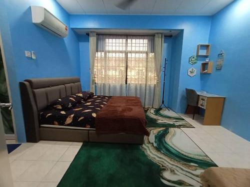 a bedroom with a bed and blue walls and a window at The Handz House II with WIFI - For family or same gender only in Kepala Batas