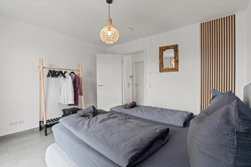 a bedroom with two beds and a clothes rack at SEEauszeit in direkter Seenähe in Friedrichshafen