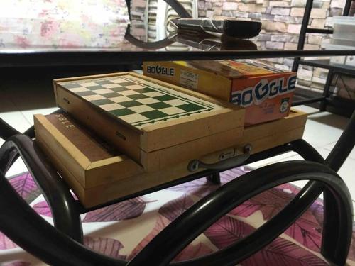a chess board and boxes on a table at 1 AC BR House 400mbps, Netflix,Parking,Massager,Cook in Rodriguez