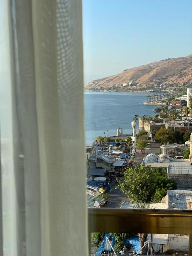 a view from a window of a harbor with a body of water at Caesar Premier Tiberias Hotel in Tiberias