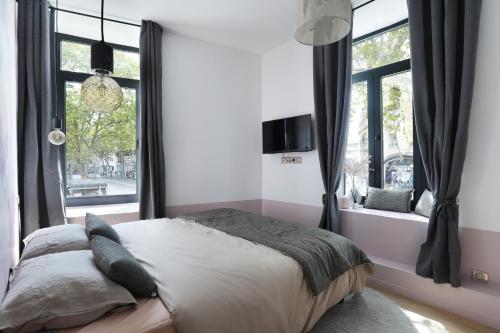 a bedroom with a bed and a window at Apartment Saint Germain des Prés by Studio prestige in Paris