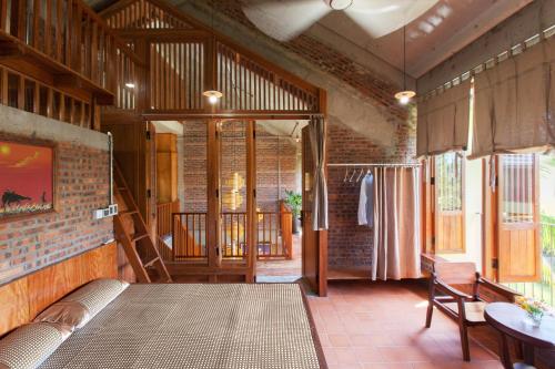 a living room with a couch and a table at Faifo Retreat Villa Hội An in An Bang