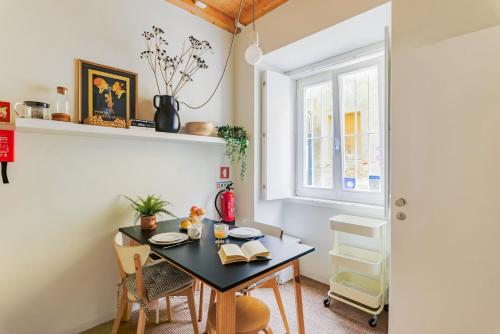 a dining room with a table and a window at Casa da Graça Lisbon Hideout in Lisbon
