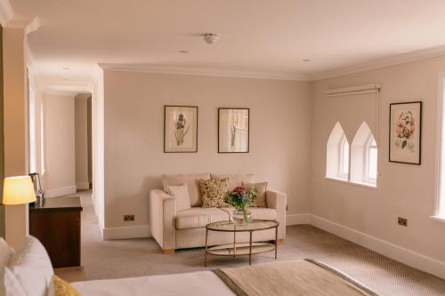 a living room with a couch and a table at The Elvetham Hotel in Farnborough