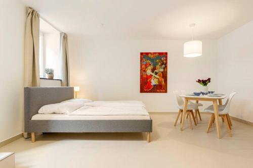 a bedroom with a bed and a table with chairs at Sleek Design in Trendy Mitte in Berlin