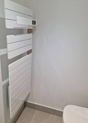 a bathroom with white cabinets and a toilet at Victoire Opale 202 climatisé hôtel de ville in Saint-Dizier