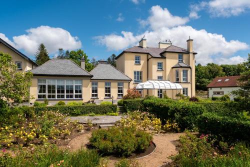 a large house with a garden in front of it at Screebe House in Rosmuck