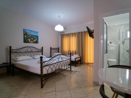 sypialnia z 2 łóżkami i kabiną prysznicową w obiekcie Vironas Hotel w mieście Himara