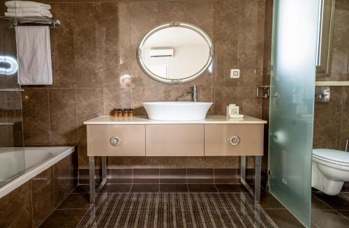 a bathroom with a sink and a mirror at Ella Sun Villa Geffen in Eilat