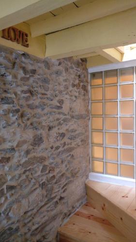 a room with a stone wall and a window at Casinhas de S. Francisco T1 Amêndoa by LovelyStay in Freixo de Espada à Cinta