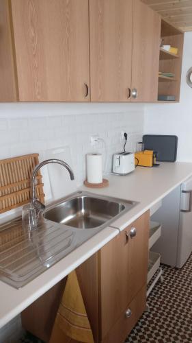 a kitchen with a sink and a counter top at Casinhas de S. Francisco T1 Amêndoa by LovelyStay in Freixo de Espada à Cinta