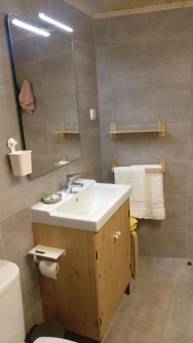 a bathroom with a sink and a toilet and a mirror at Casinhas de S. Francisco T1 Amêndoa by LovelyStay in Freixo de Espada à Cinta