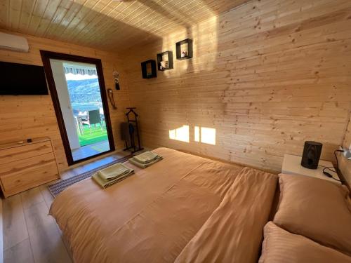 a bedroom with a large bed and a window at Casa pe lac Bicaz in Bicaz