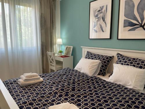 a bedroom with a bed with a blue wall at Opatovina in Topusko