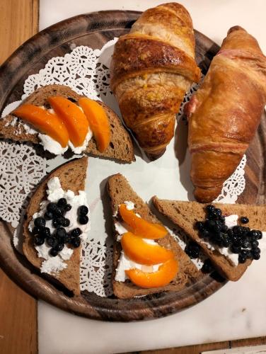 a plate of bread and pastries on a table at b&b La Corte dei Cerri- Il Piccolo Chalet in Frassinoro
