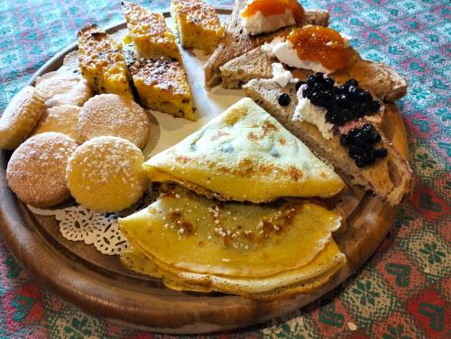a plate of pastries and desserts on a table at b&b La Corte dei Cerri- Il Piccolo Chalet in Frassinoro