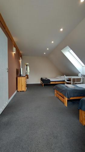 a large room with two beds and a skylight at Rezydencja Ostoja in Stronie Śląskie