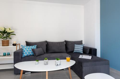 a living room with a couch and a table at PROPAN CITY SUITES in Volos