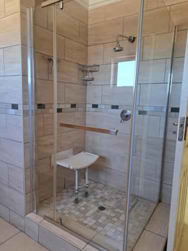 a shower with a sink in a bathroom at Onyx Villa in Kimberley
