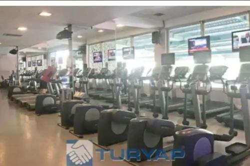 a gym with rows of cardio equipment in a gym at Eltes Gold Residance in Umraniye