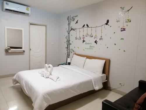 a bedroom with a bed with a stuffed animal on it at ruamsab apartment1 in Bangkok